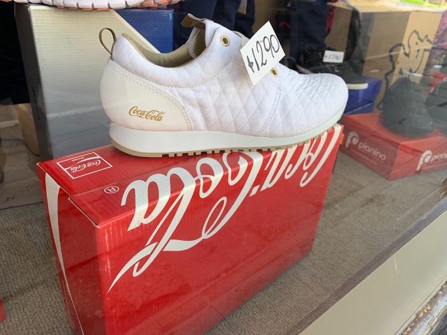In a shop in town, they're selling Coca-cola shoes?