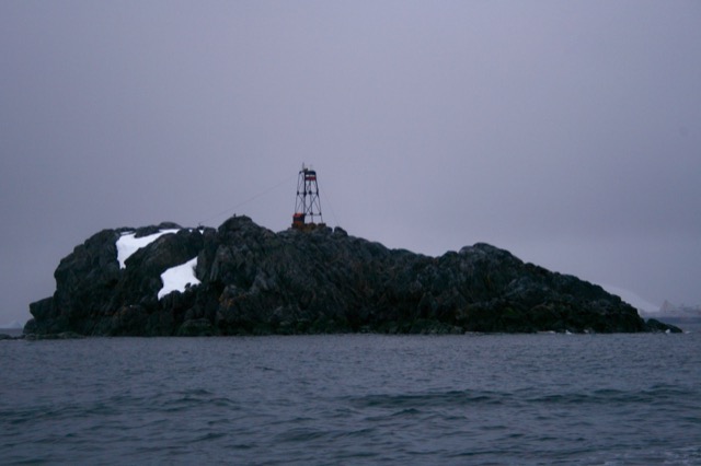 Lighthouse with our ship off in the distance