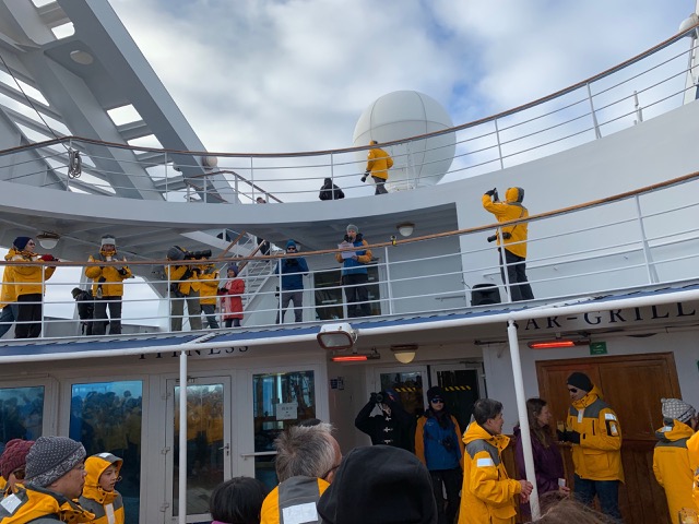 Expedition Leader, Laurie, reads a speech as we cross the Circle