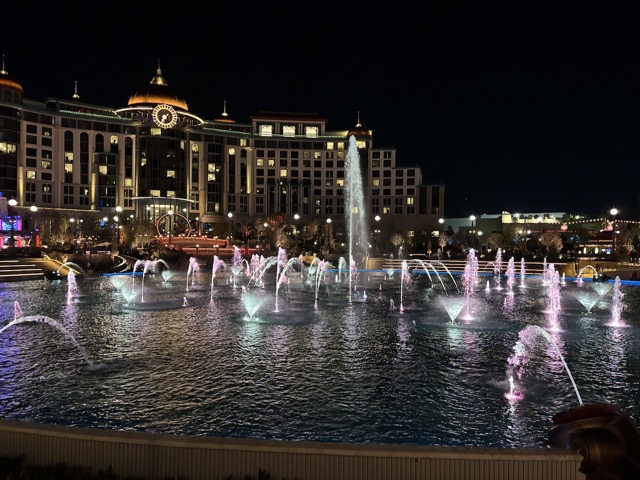 Fountains in the middle of the park with the hotel overlooking it