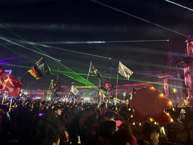 Lasers fly through the flags of the crowd