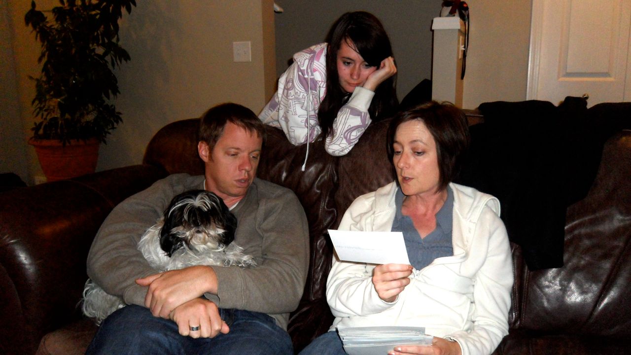 Rob, Jenna, and Nicola looking at old pictures