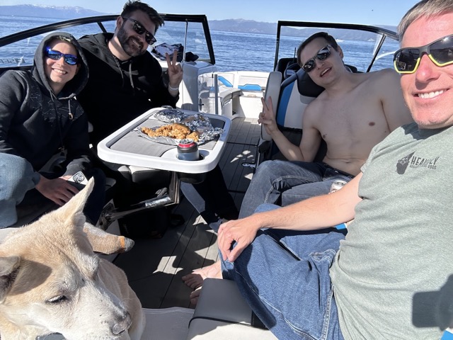 Chelsea, James, Miles, Geno, and Myke having chicken fingers on the boat