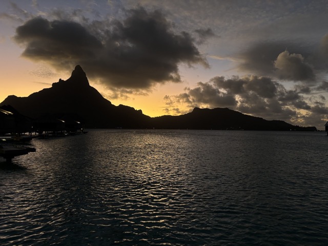 The sun setting behind the mountain