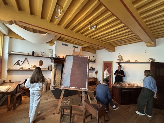 Rembrandt's studio showing a canvas being prepped with a base layer