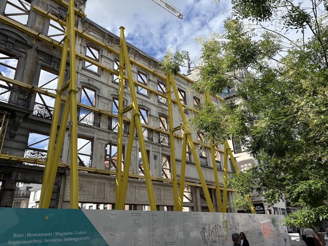Original building façade being supported during construction