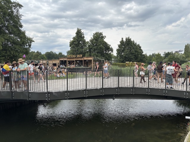 Bridge to the Elixir stage with a Tattoo shop in the background