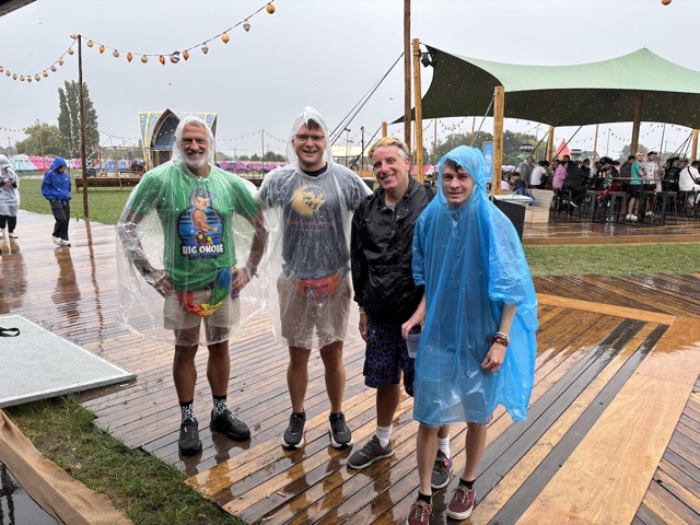 Jared, Brennan, Myke, and Harris in ponchos in the rain