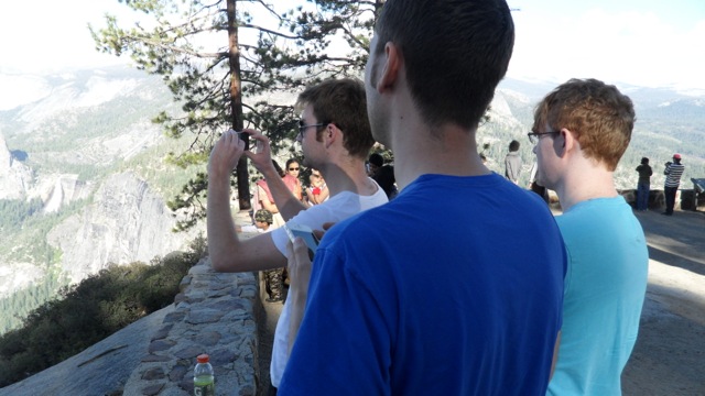 Ryan taking a picture with Eric and Jaxon looking on